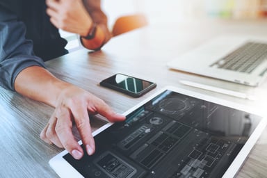 Website designer working digital tablet and computer laptop with smart phone and graphics design diagram on wooden desk as concept Website designer working digital tablet and computer laptop with smart phone and graphics design diagram on wooden desk as concept
